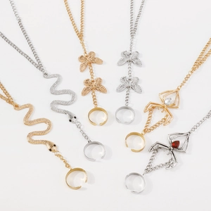 Detailed macro view showing diverse gold and silver spider, snake and butterfly hand chains
