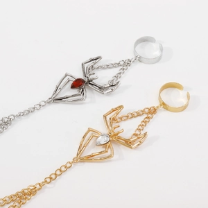 Gothic hand harness detail featuring a spider design with red and white gemstones