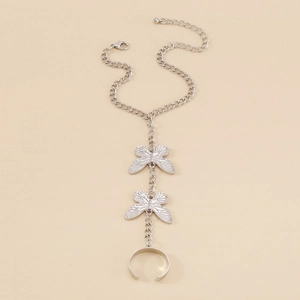 Detailed view of silver slave bracelet featuring butterfly charms and an open ring