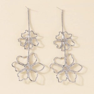 Detail of silver floral tassel earrings with double hollow flowers and snake chain