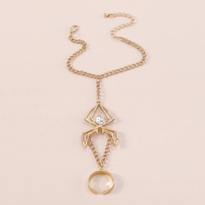 Detailed macro shot of a gothic gold spider hand harness with white water drop crystal