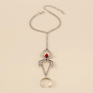 Gothic silver spider hand chain with red gemstone detail and adjustable ring