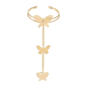 Detailed macro view of the gold hollow butterfly hand harness and ring set