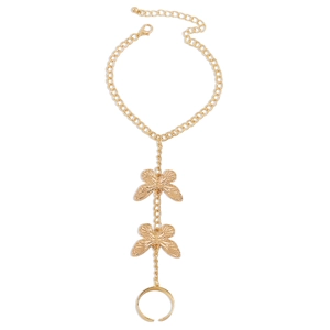 Detail of gold butterfly bracelet-ring with intricate engraved textures and adjustable chain
