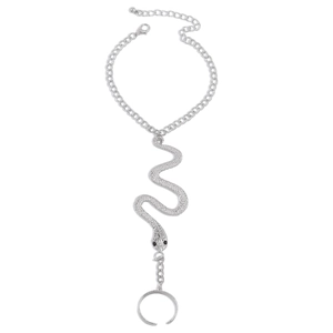 Macro detail of silver gothic snake hand chain featuring intricate engraved textures