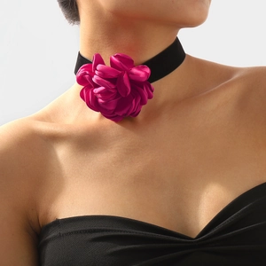 Close-up of a large magenta fabric rose choker necklace with a black velvet band