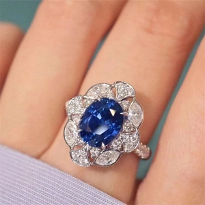 Royal blue sapphire floral ring with marquise cut diamonds and pavé setting