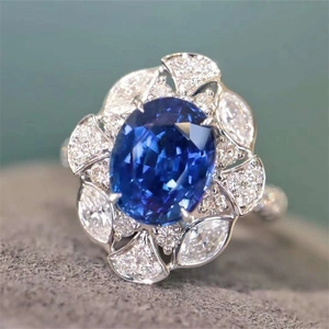 Elegant floral open ring with royal blue sapphire center and shimmering diamonds