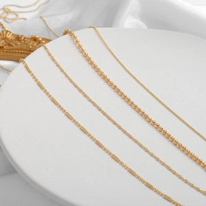 Four styles of 18K gold plated beaded necklaces showing different link textures and shine