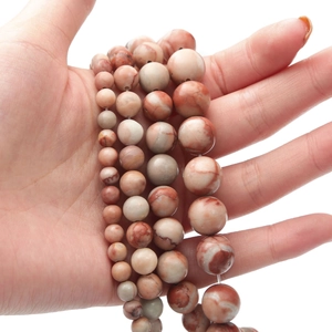 Macro detail of natural pink pastel stone beads in four sizes for DIY jewelry making