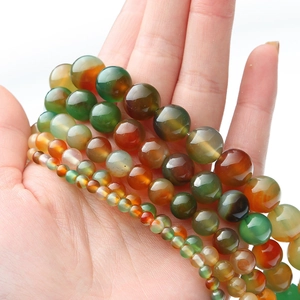 Macro shot showing various sizes of colorful agate round beads from 4mm to 12mm