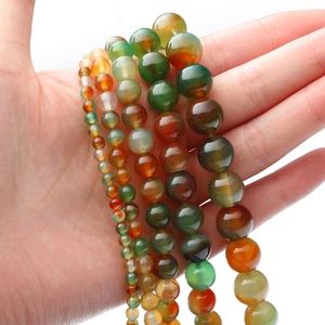Detail of colorful striped peacock agate round beads in various sizes for DIY jewelry