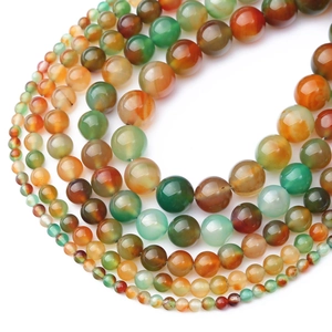 Macro shot of colorful peacock agate beads with natural textures for jewelry making