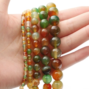 Macro detail of natural agate beads in various sizes and vibrant colors for DIY jewelry