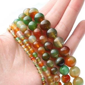 Macro view of multi-color peacock agate beads showing various sizes and smooth textures