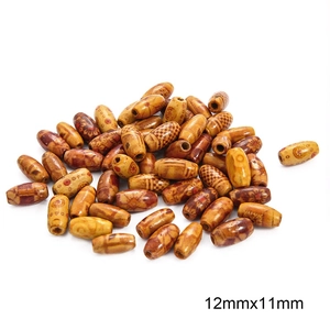 Macro view of 12mm wenge wood spacer beads with traditional engraved ethnic patterns