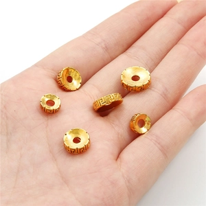 DIY jewelry 24K gold plated spacers with traditional Greek fret pattern in hand