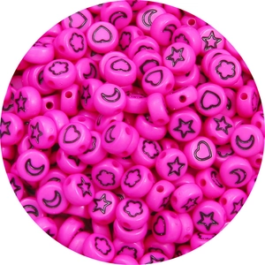 Macro shot of pink acrylic star and moon beads with holes for DIY jewelry making