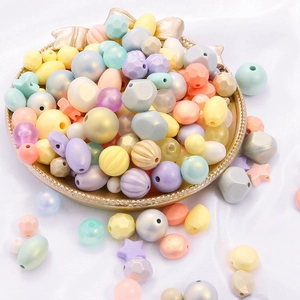 DIY colorful acrylic macaroon beads in various geometric shapes on a luxury display tray