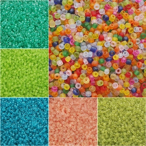 Macro detail of mixed frosted and transparent glass seed beads for DIY jewelry making