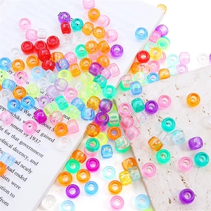 Flat lay of colorful acrylic large hole pony beads for DIY jewelry and hair braids