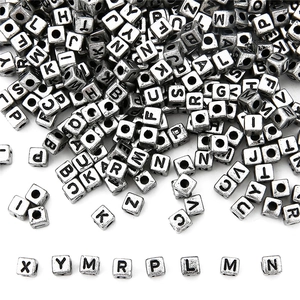 Close-up of 5x5mm vintage silver acrylic square alphabet beads for DIY jewelry making