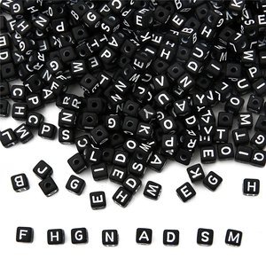Detailed view of 5mm black acrylic square letter beads with white alphabet for DIY jewelry