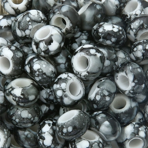 Macro shot of DIY beads with artistic black and white ink marble texture pattern