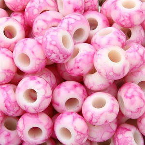 Macro shot of pink and white marble texture resin beads for DIY jewelry making
