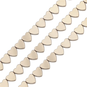 Close-up of heart-shaped champagne gold hematite loose beads for DIY jewelry making