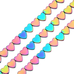 Detailed view of rainbow electroplated hematite heart beads for jewelry making