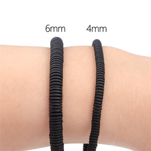 Polished black hematite disc beads for DIY jewelry in 4mm and 6mm sizes shown on wrist