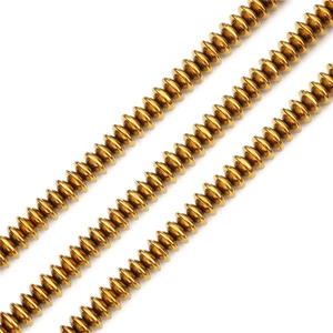 Macro shot of gold plated flat spacer beads for jewelry making with metallic reflection