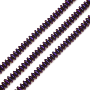 Macro detail of aurora purple plated hematite disc beads for DIY jewelry making