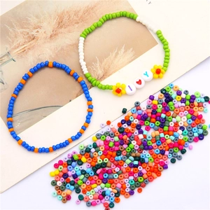 Detail view of colorful glass seed beads and DIY handmade bracelets with floral charms