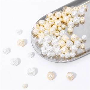 Macro detail of acrylic rose pearl beads with spiral petals and holes for DIY jewelry