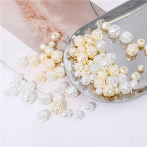 Macro shot of rose-shaped acrylic pearls in white and cream for DIY jewelry making