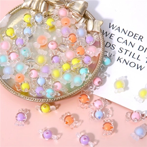Colorful macaron acrylic candy beads for DIY jewelry making on a decorative tray