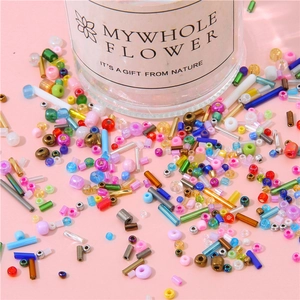 Macro view of colorful mixed glass seed beads and bugle beads for DIY jewelry making