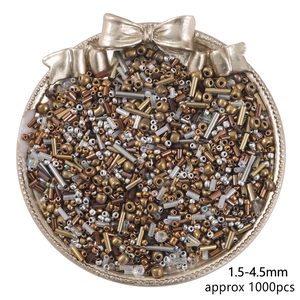 Macro detail of mixed glass seed beads in metallic tones for DIY jewelry making
