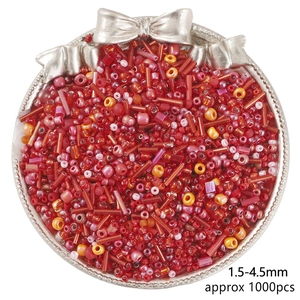 Mix of red and pink 1.5-4.5mm glass seed beads for DIY jewelry in a silver tray