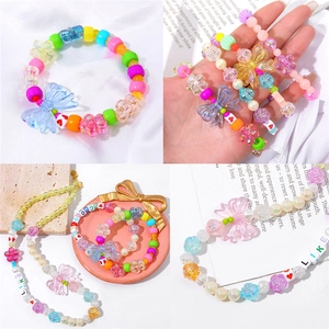 Detail of colorful acrylic flower beads and heart charms on DIY necklaces and bracelets
