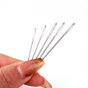 Five pieces of large eye hand sewing needles in various sizes on white background