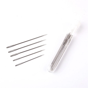 Macro shot of large-eye sewing needles set with a clear plastic storage tube storage