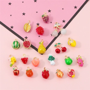 Flat lay of colorful alloy fruit and vegetable enamel pendants for DIY jewelry making