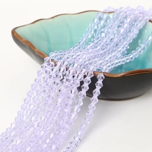 Strands of 6mm lavender bicone faceted crystal beads spilling from a decorative bowl