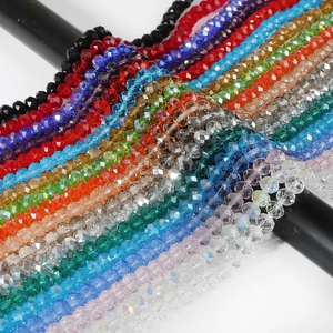 Macro shot of 8mm faceted crystal rondelle beads in various vibrant colors for DIY jewelry