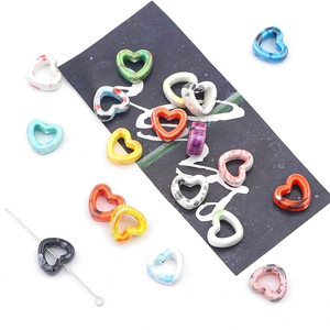 Macro shot of colorful heart ceramic beads showing vertical holes for DIY jewelry