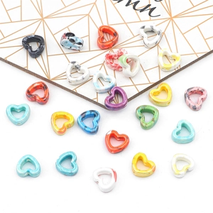 Macro shot of colorful marbled heart-shaped ceramic beads for DIY jewelry making accessories