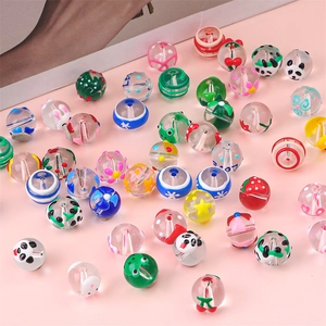 Detailed view of colorful hand-painted glass beads with animal and floral patterns for DIY